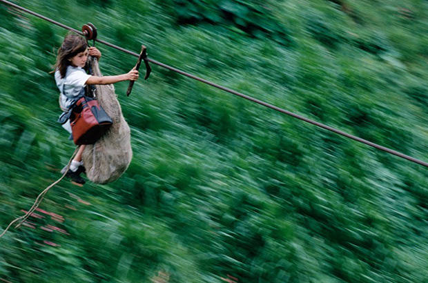 The harrowing crossing of a young girl clinging to jute rucksack containing her brother, who at five, is too young to make the crossing alone