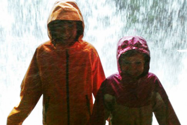 Standing behind a waterfall