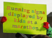 Running Signs Displayed By Kids At A Marathon