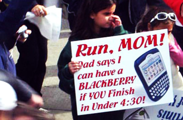 Kid Running Signs At A Race #10: Run, Mom. Dad says I can have a Blackberry if you finish in under 4:30.